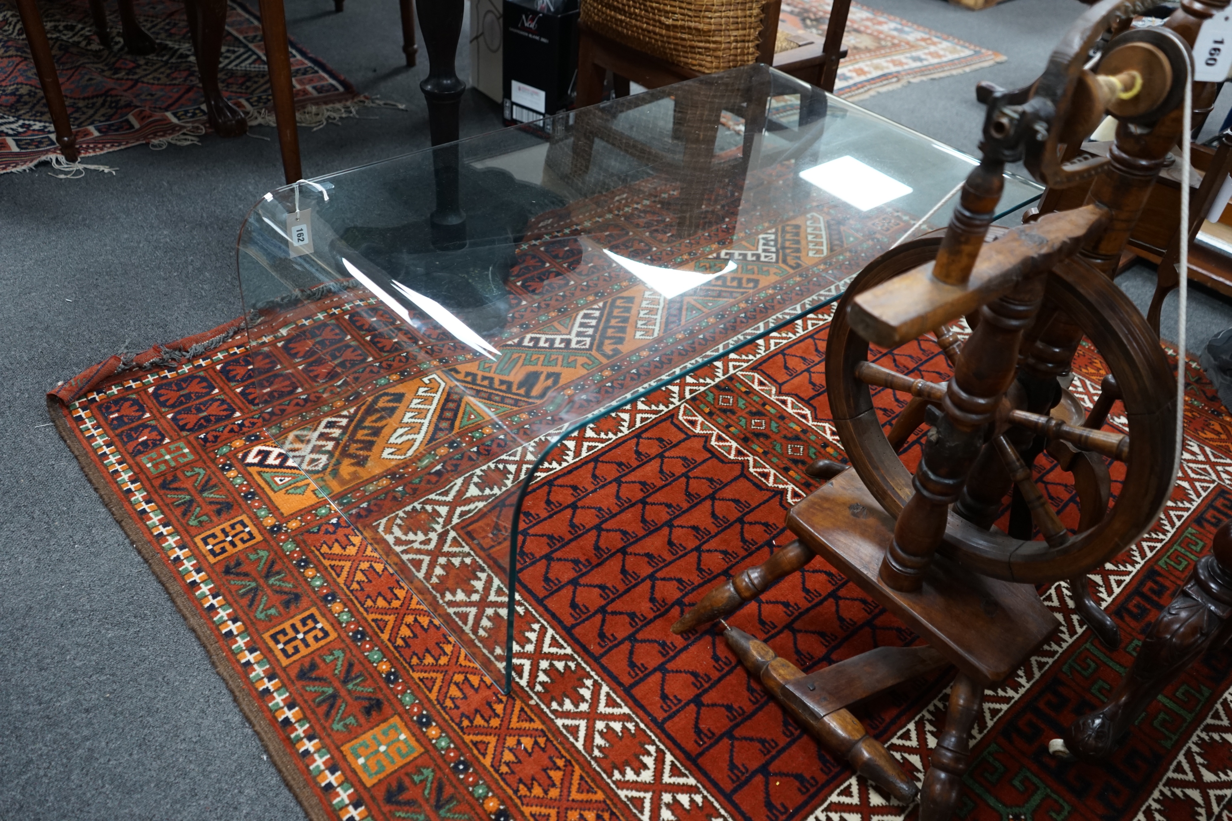 A contemporary curved glass coffee table, width 110cm, depth 60cm, height 38cm